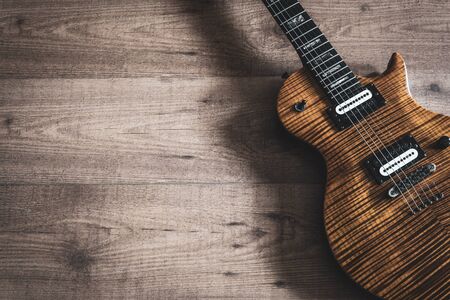 Electric guitar on wooden background