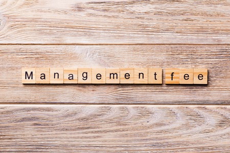 Management fee word written on wood block management fee text on wooden table for your desing concept Stock Photo