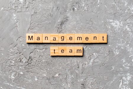 Management team word written on wood block management team text on cement table for your desing concept