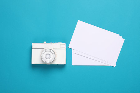 Cámara blanca con fotografías en blanco sobre fondo azul plantilla de maqueta de diseño creativo para diseño