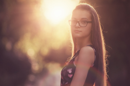 Outdoor photos of beautiful young women from sunset in the background