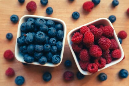 Blueberries and raspberries healthy forest berry fruit top view