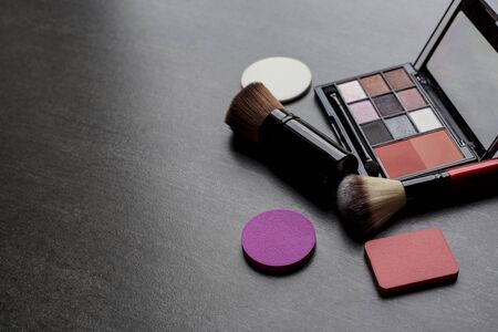 Set of colorful cosmetics on black background