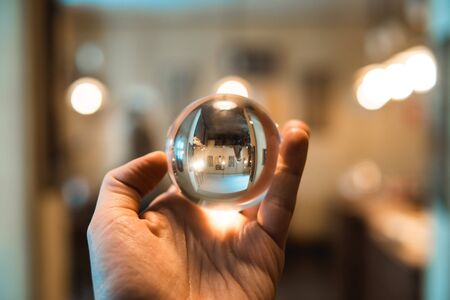 Man holding a clean glass bowl in the room