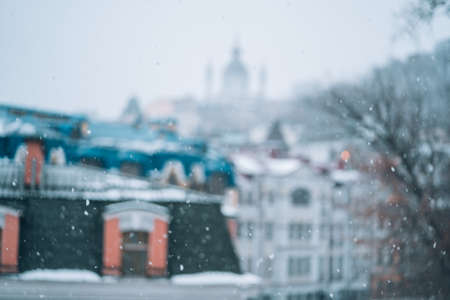 Copious snowfall over the city with the roofs Фото со стока