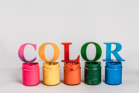 The colorful word color put on screen printing ink glass bottles in white background with copy space