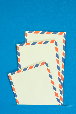 Three air mail envelope interpolate on blue background Stock Photo