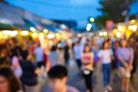 Blurred background of people shopping at night market walking street