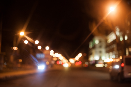 Night city street lighting lanterns and cars