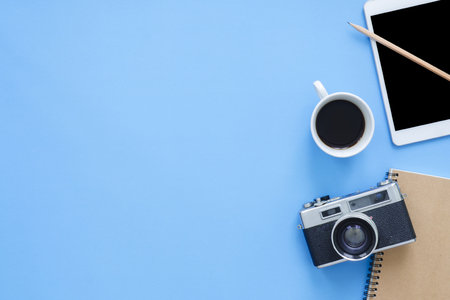 Office desk working space flat lay top view mockup photo of working space with smart device coffee cup and notebook on blue pastel background pastel blue color copy space working desk concept