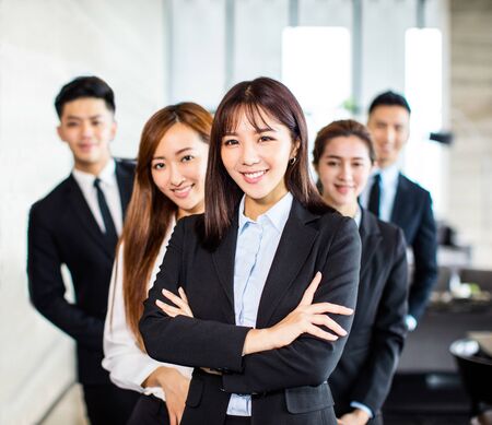 Confident asian business team stands in office Stock Photo