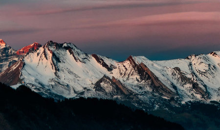 Beautiful alpine landscape with snowcapped mountains at sunset