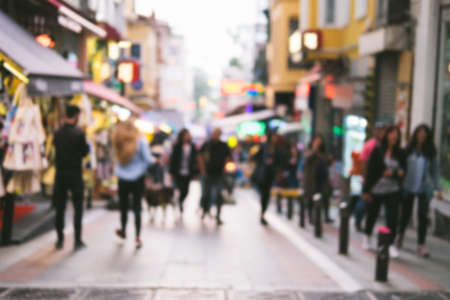 Bright defocused blurred background with unrecognizable people on the sity street abstract image of crowd of people in public place