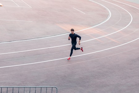 Top view athlete running on running track runner sprinting on red running track in stadium