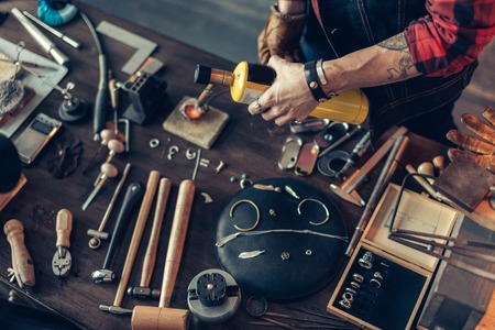 Man creating a jewellery at workshop close up top view photo Stock Photo