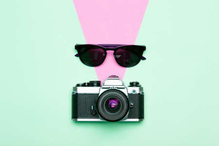 Photo camera creative concept background vintage retro photo camera on a colored background travel vacation and photography concept