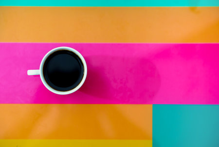 Coffee in cup on colorful background