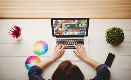 Overhead view of businesswoman using laptop at her desk Stock Photo