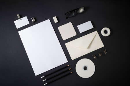 Blank corporate stationery set on black paper background branding mock up flat lay