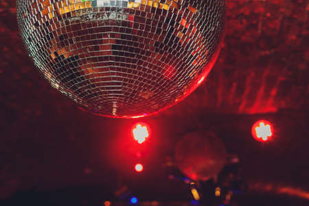 Colorful disco mirror ball lights night club background Stock Photo