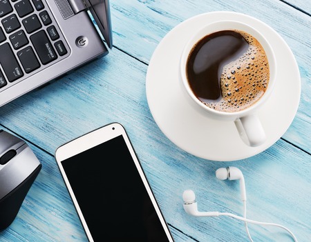 Coffee break office table with different gadgets on it top view