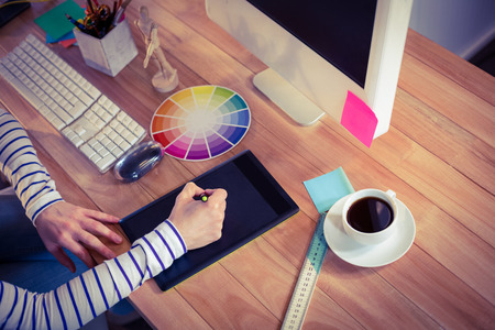 Designer using digitizer on desk in creative office