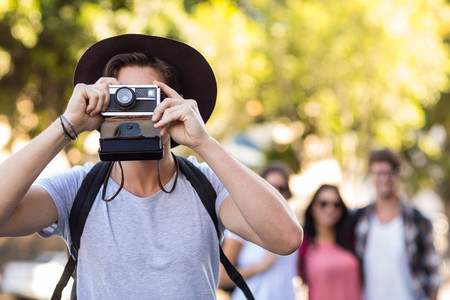 Hip man taking picture with polaroid in the city Stock Photo