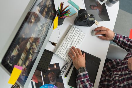 Mid section close up of handsome young caucasian male graphic designer working on computer at desk in office modern casual creative business concept Stock Photo