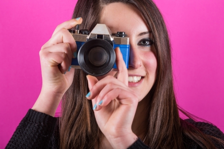 Young woman with toy camera