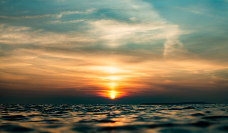 A beautiful shot of a colorful magnificent over the sea with calm waves