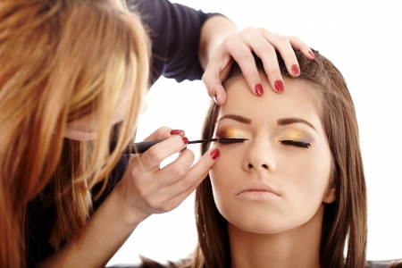 Closeup of a makeup artist applying makeup Stock Photo