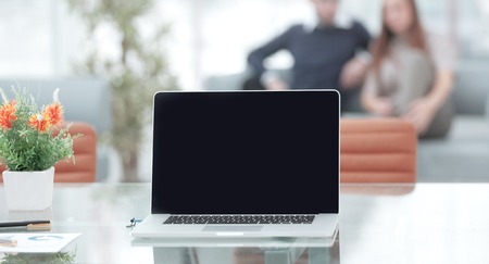 Close up open laptop computer on a glass desk in the office Stock Photo