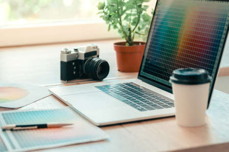 Close up laptop camera and color palette on the table of designer