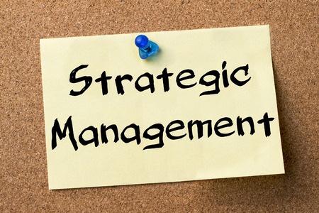 Strategic management adhesive label pinned on bulletin board horizontal image Stock Photo