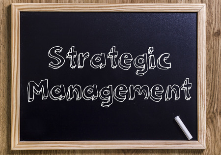 Strategic management new chalkboard with 3d outlined text on wood