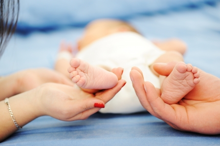 Parents holding baby feet