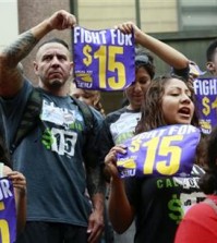 FILE - In this Tuesday, July 21, 2015 file photo, workers hold a rally in Los Angeles in support of the Los Angeles County Board of Supervisors' proposed minimum wage ordinance. On Saturday, March 26, California legislators and labor unions reached an agreement that will take the state's minimum wage from $10 to $15 an hour. (AP Photo/Nick Ut)