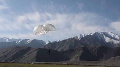 Special operations troops parachute in plateau area
