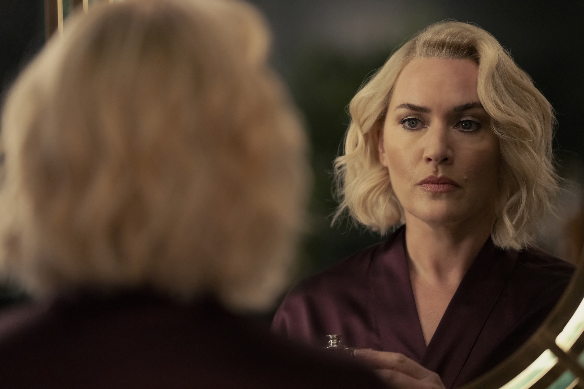 Kate Winslet looks at herself in a mirror in 'The Regime'