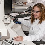 Technician using an Electron Microscope.