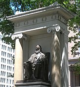 The monument to Peter Cooper sits between the Foundation Building and the park at Cooper Triangle