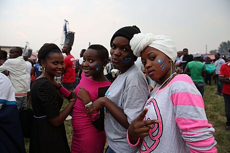 Congolese women with painted national flags on their cheeks, celebrating at the Amani Festival in Goma