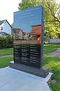 The granite memorial in 2019 listing the names of the victims