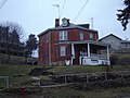 Plain brick house with no decorative features except a modest front veranda. Robert Waugh House, Sparland, Illinois (built in 1886).