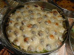 Moche from the Philippines, a boiled buchi variant with bean paste filling served with sweetened coconut milk sauce