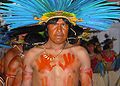 Bororo Indian with feather headdress and body painting.