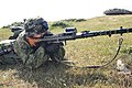 A Gurttrommel attached to the receiver of an MG 34 on its bipod during a reenactment