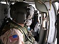 A UH-60 Black Hawk door gunner in Iraq (2005) wearing the HGU-56/P Maxillofacial Shield made by Gentex. The shield improves communication and protects from rotor wash effects.