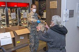 A Colorado National Guardsman offering food aid in Denver.