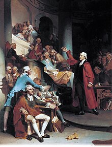 Upper-class middle-aged man dressed in a bright red cloak speaks before an assembly of other angry men. The subject's right hand is raise high in gesture toward the balcony.